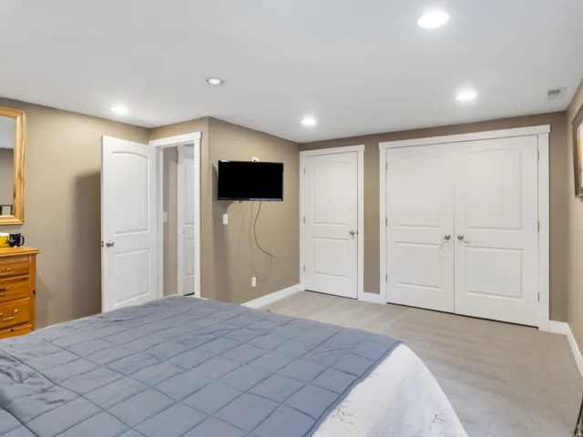 ADU Bedroom featuring light tan walls, recessed lighting, and carpet flooring