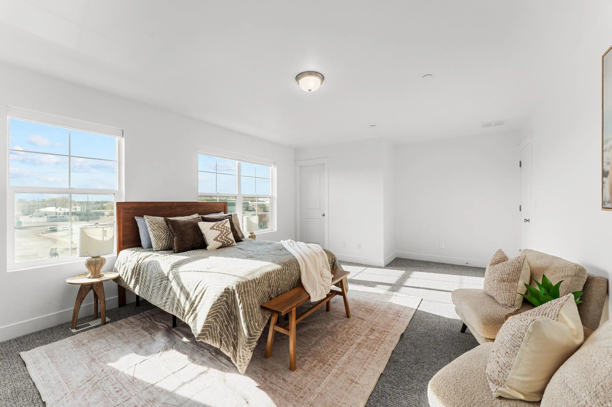 Bedroom with light carpet and baseboards