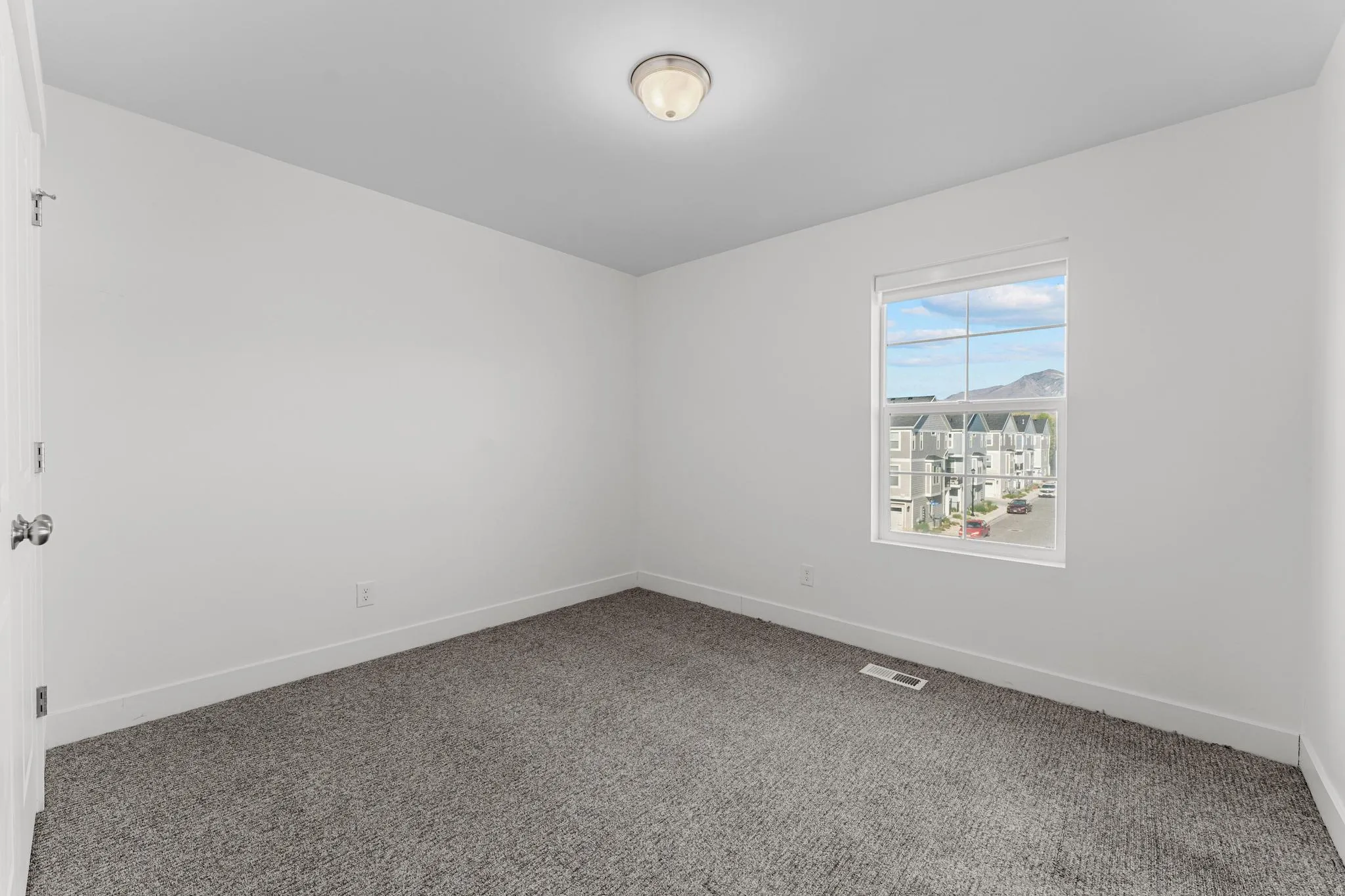 Carpeted empty room featuring baseboards