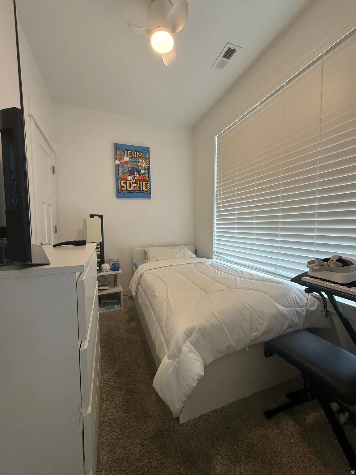 Bedroom featuring dark carpet and ceiling fan