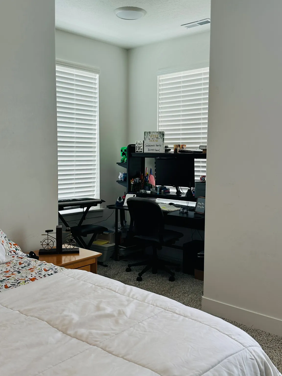 Bedroom featuring carpet and an office area