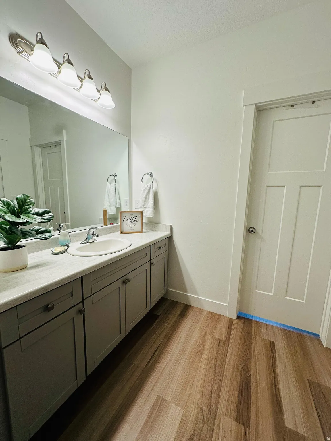 Bathroom featuring vanity, dark wood finished floors, and a textured ceiling