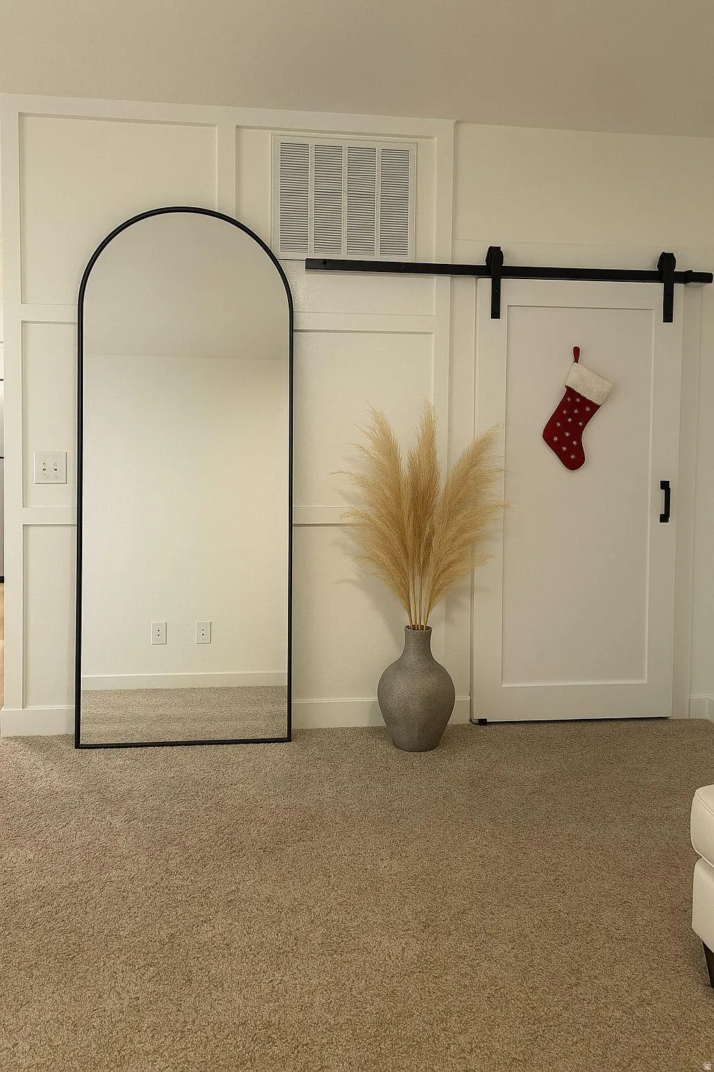 Detailed view of carpet floors and a barn door