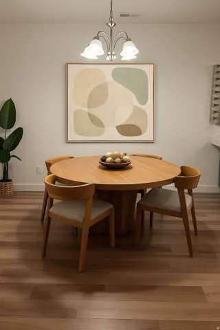Dining space with wood finished floors and suspended lighting