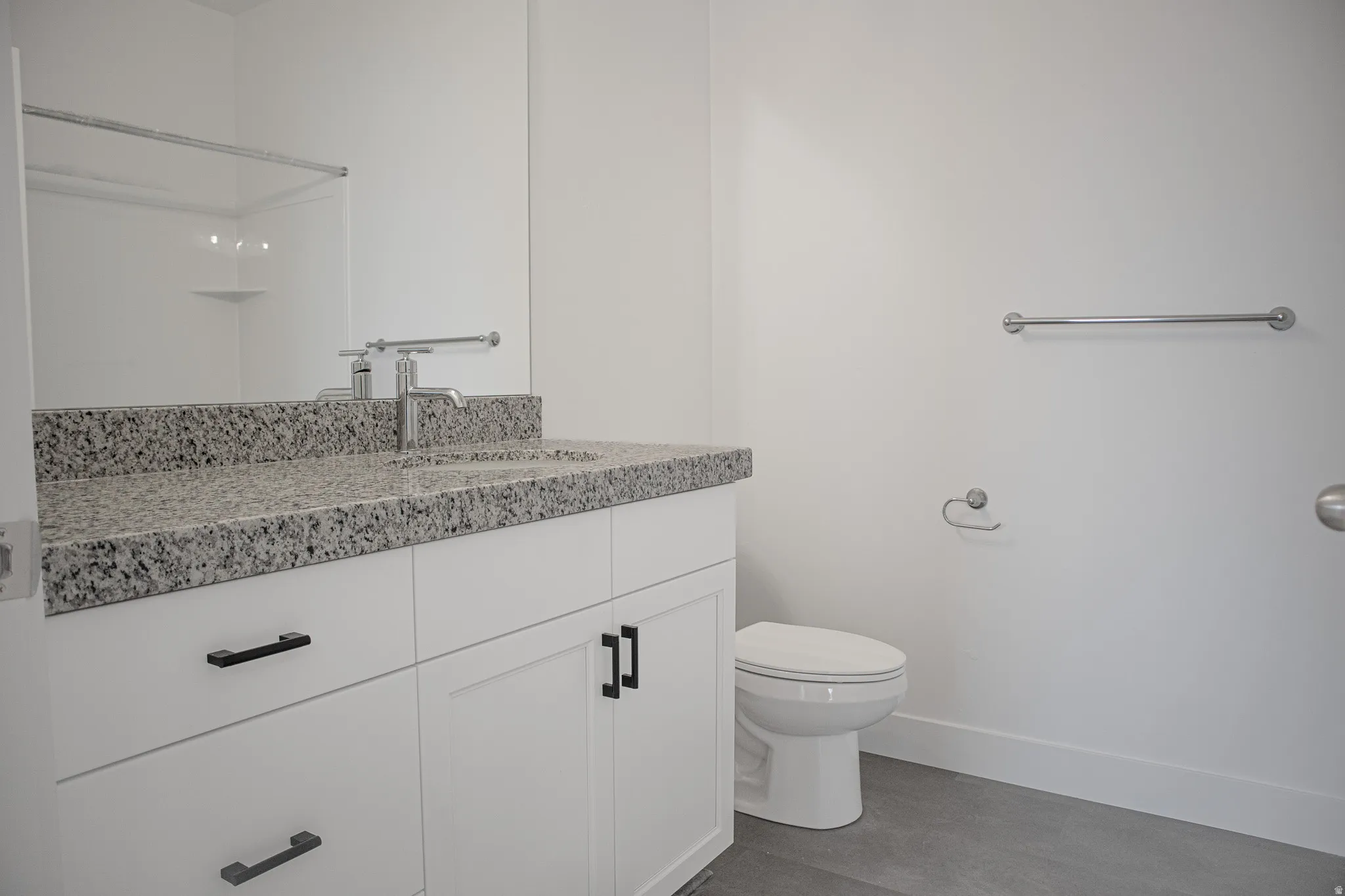 Full secondary bath with painted white wood cabinets and granite countertops.