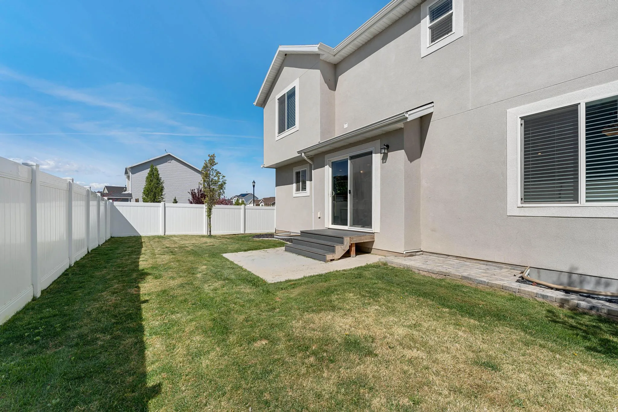Fenced backyard featuring a patio
