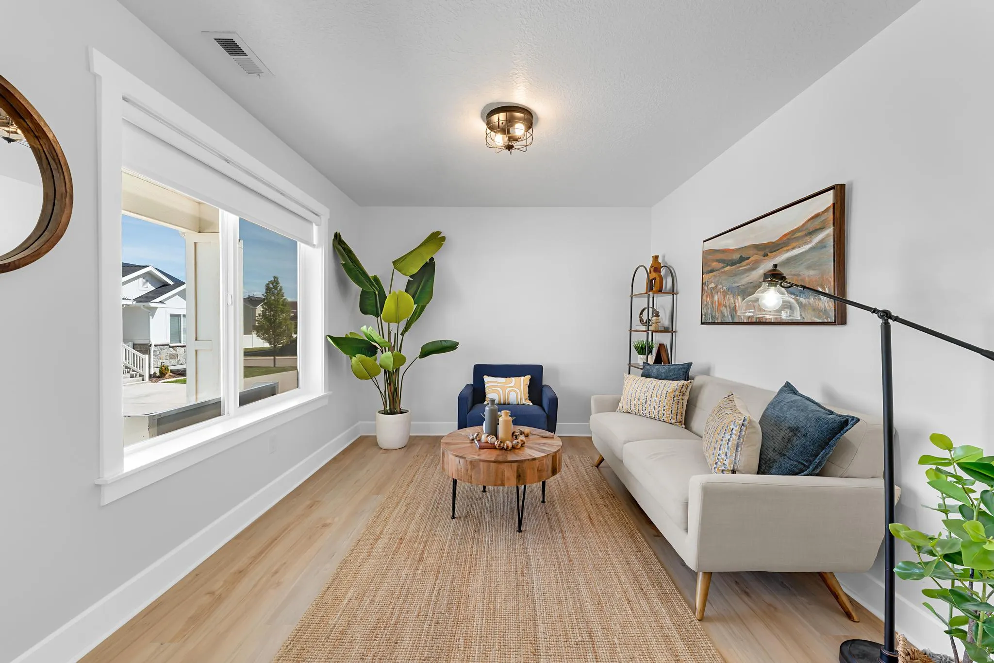 Sitting room featuring light wood-style floors and baseboards