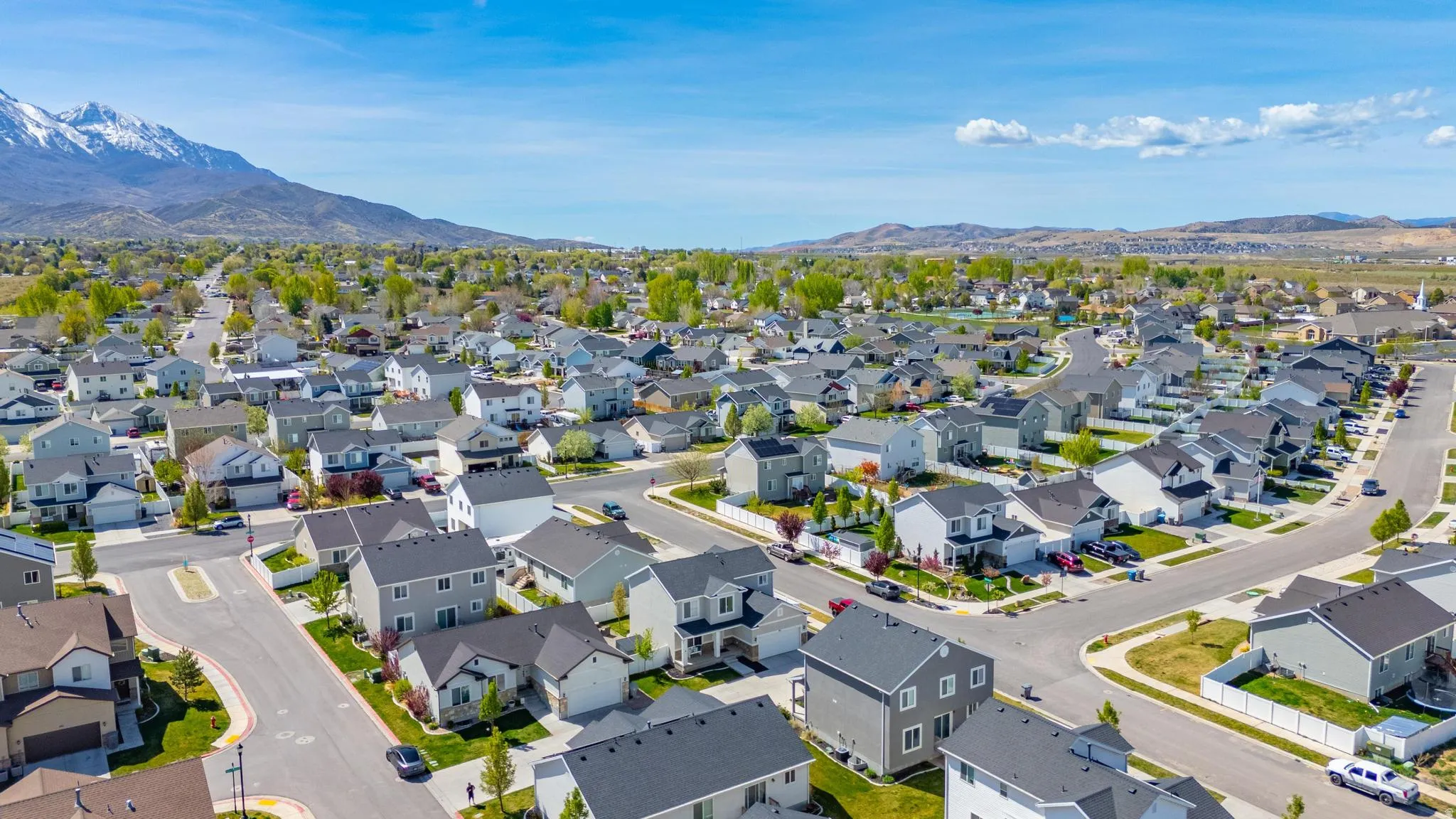 Aerial perspective of suburban area featuring a mountain backdrop
