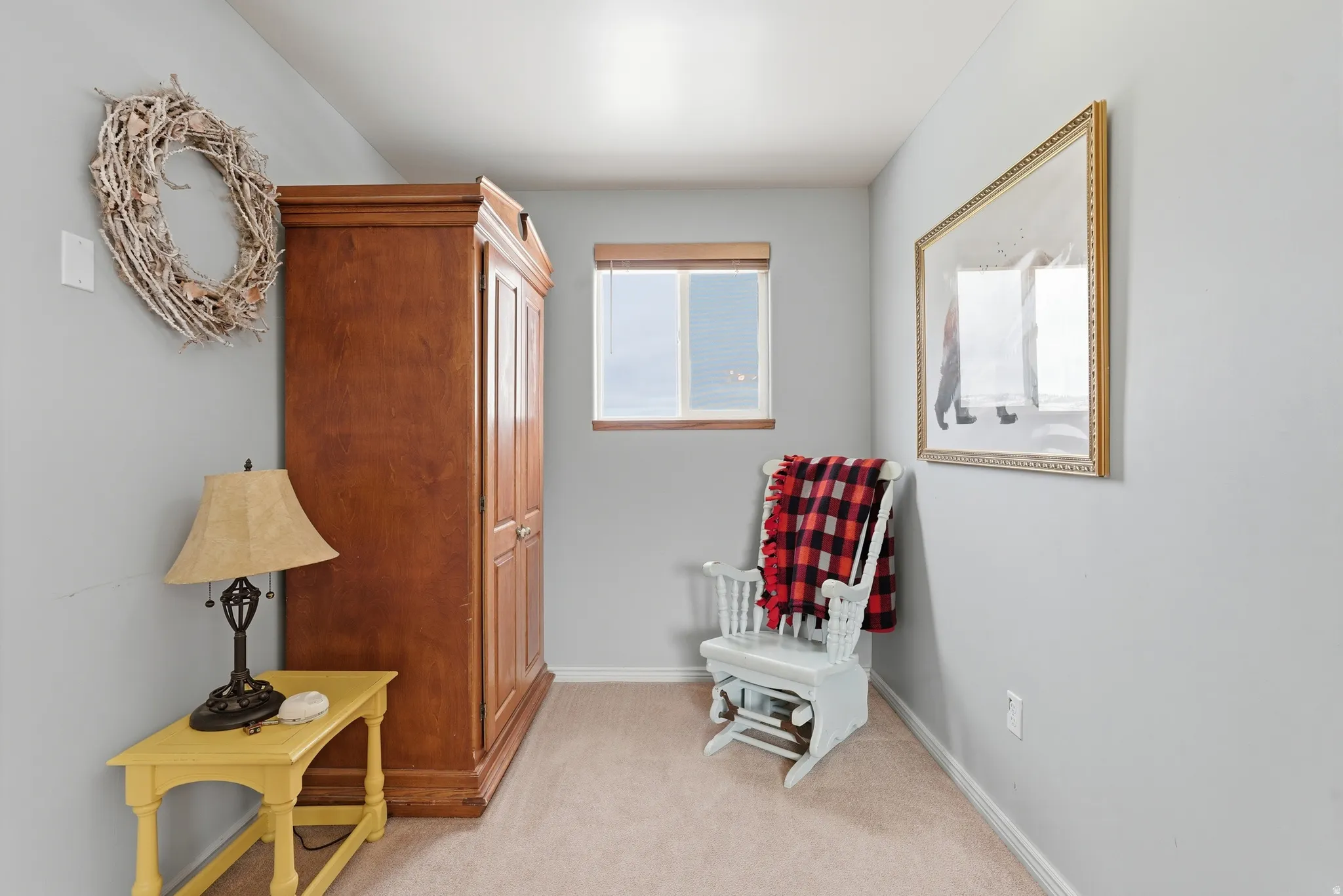 Sitting room featuring light colored carpet and baseboards