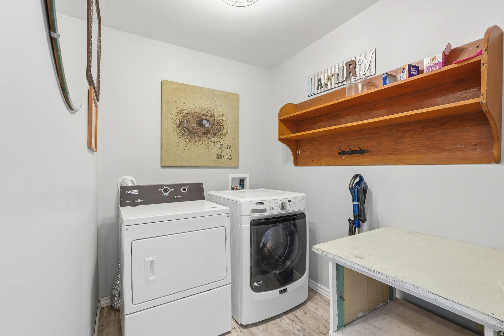 Laundry area featuring washing machine and dryer and light wood finished floors