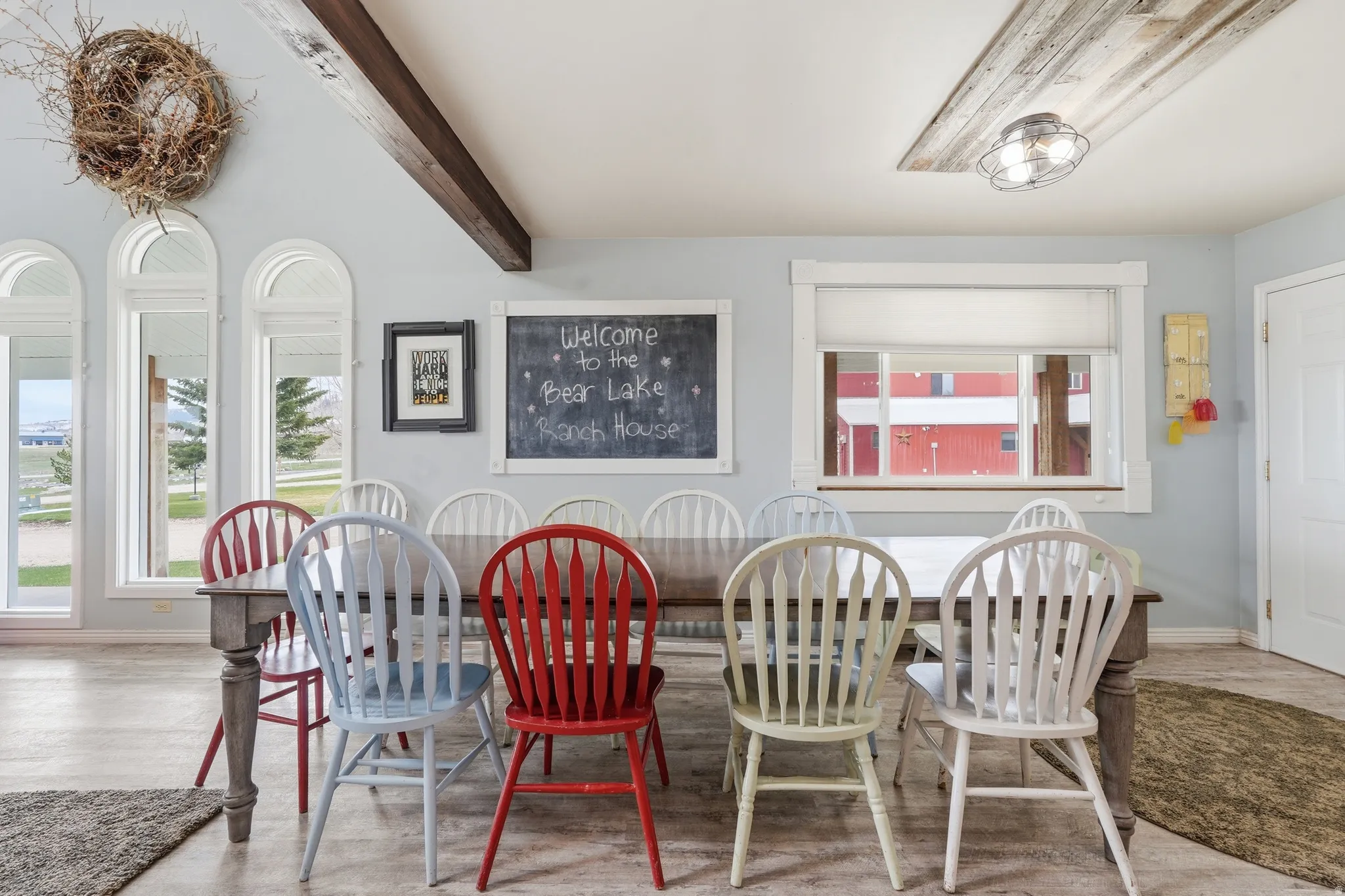 Dining space featuring beamed ceiling and wood finished floors