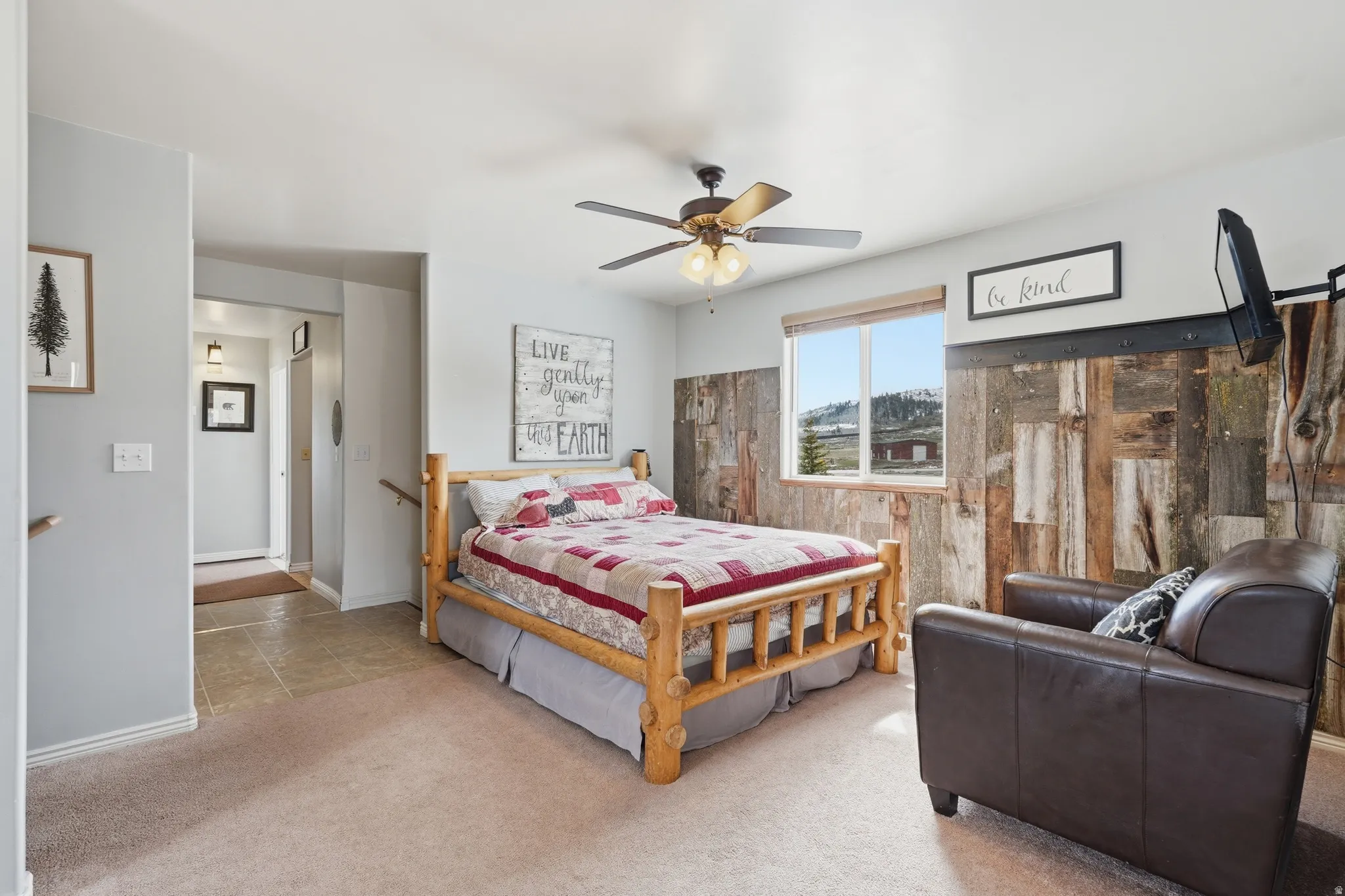 Bedroom with light colored carpet and a ceiling fan