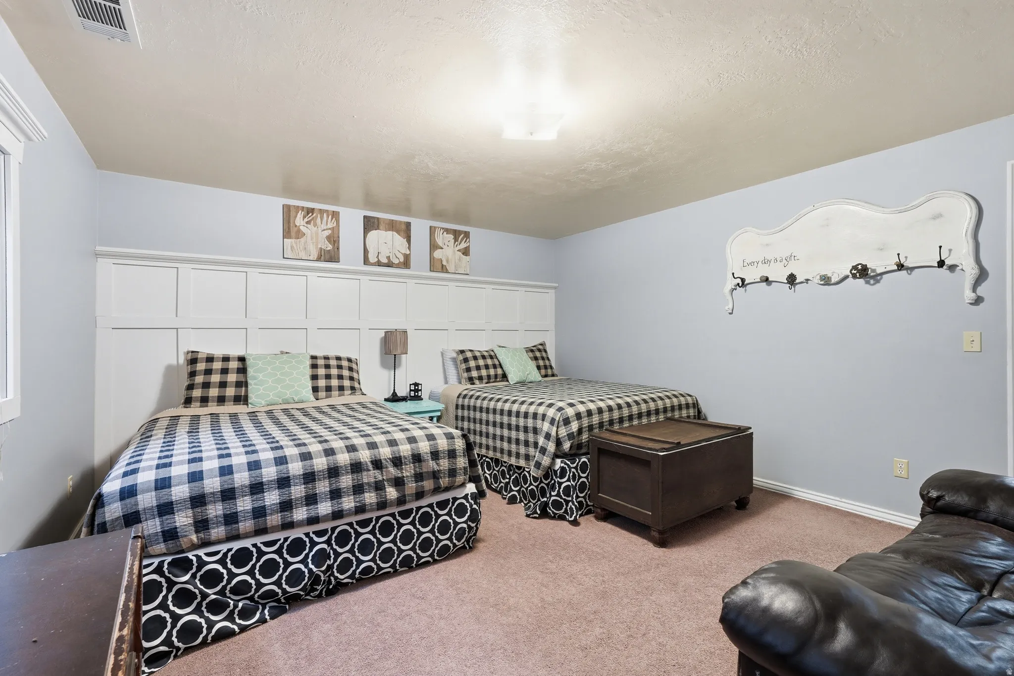 Bedroom featuring carpet floors and a textured ceiling