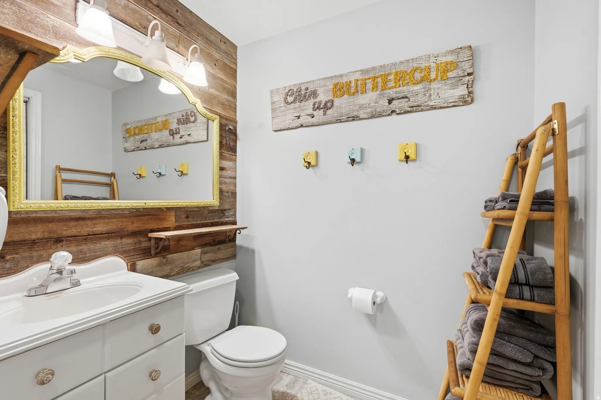 Half bath featuring vanity and wooden walls
