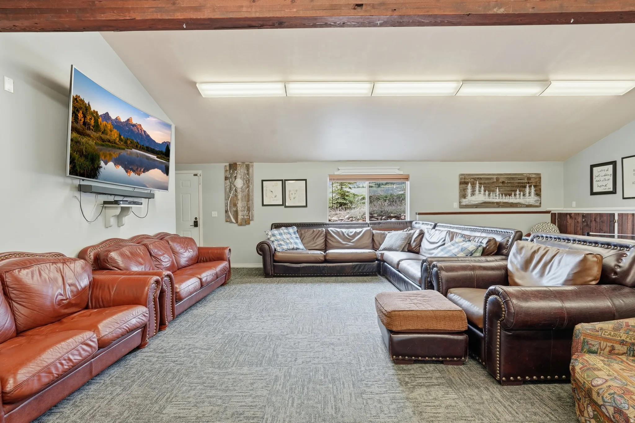 Carpeted living area with vaulted ceiling