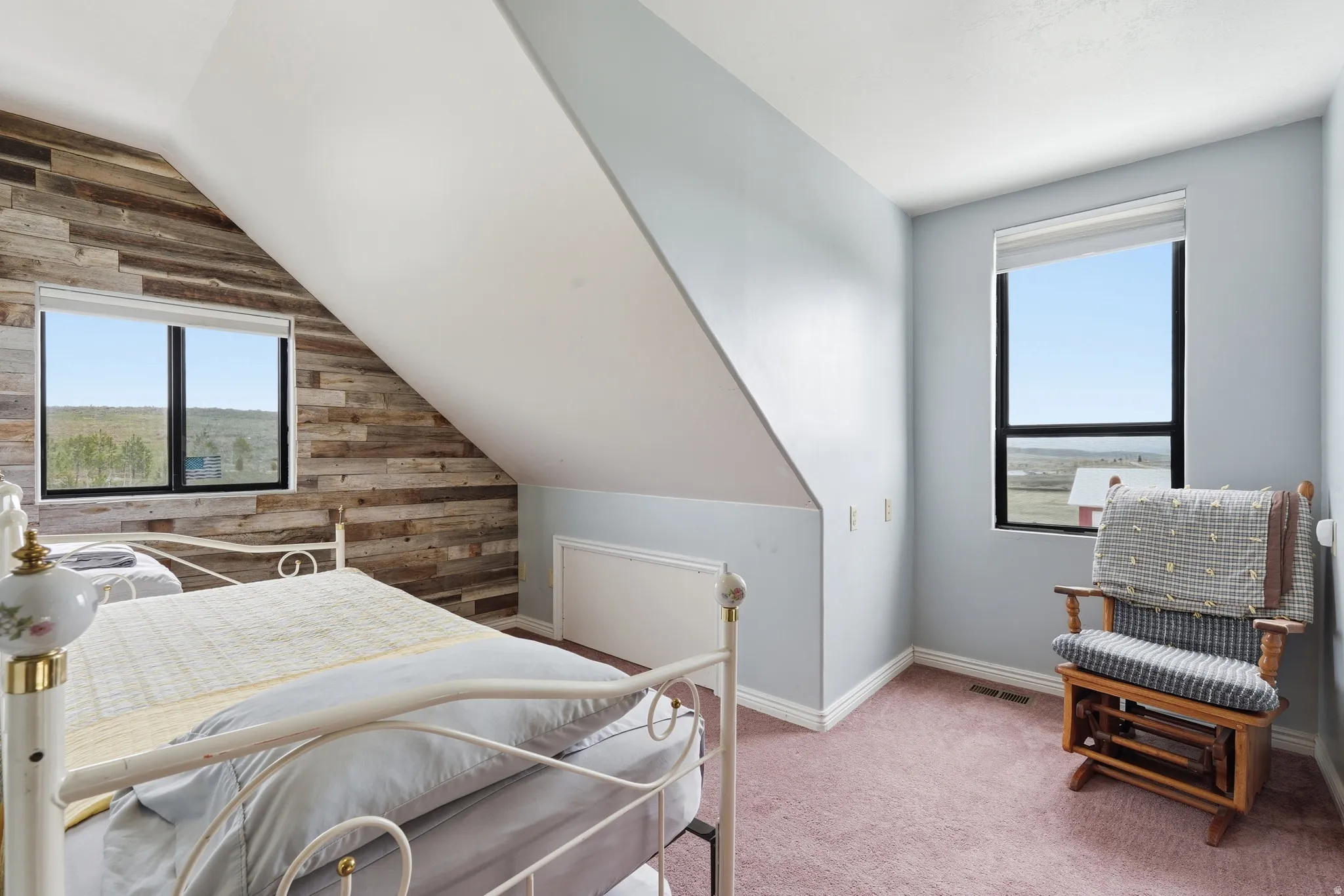 Bedroom with light carpet and vaulted ceiling