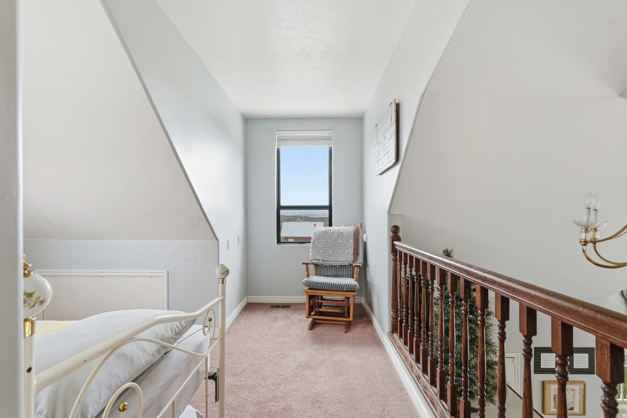 Bedroom featuring light carpet and baseboards