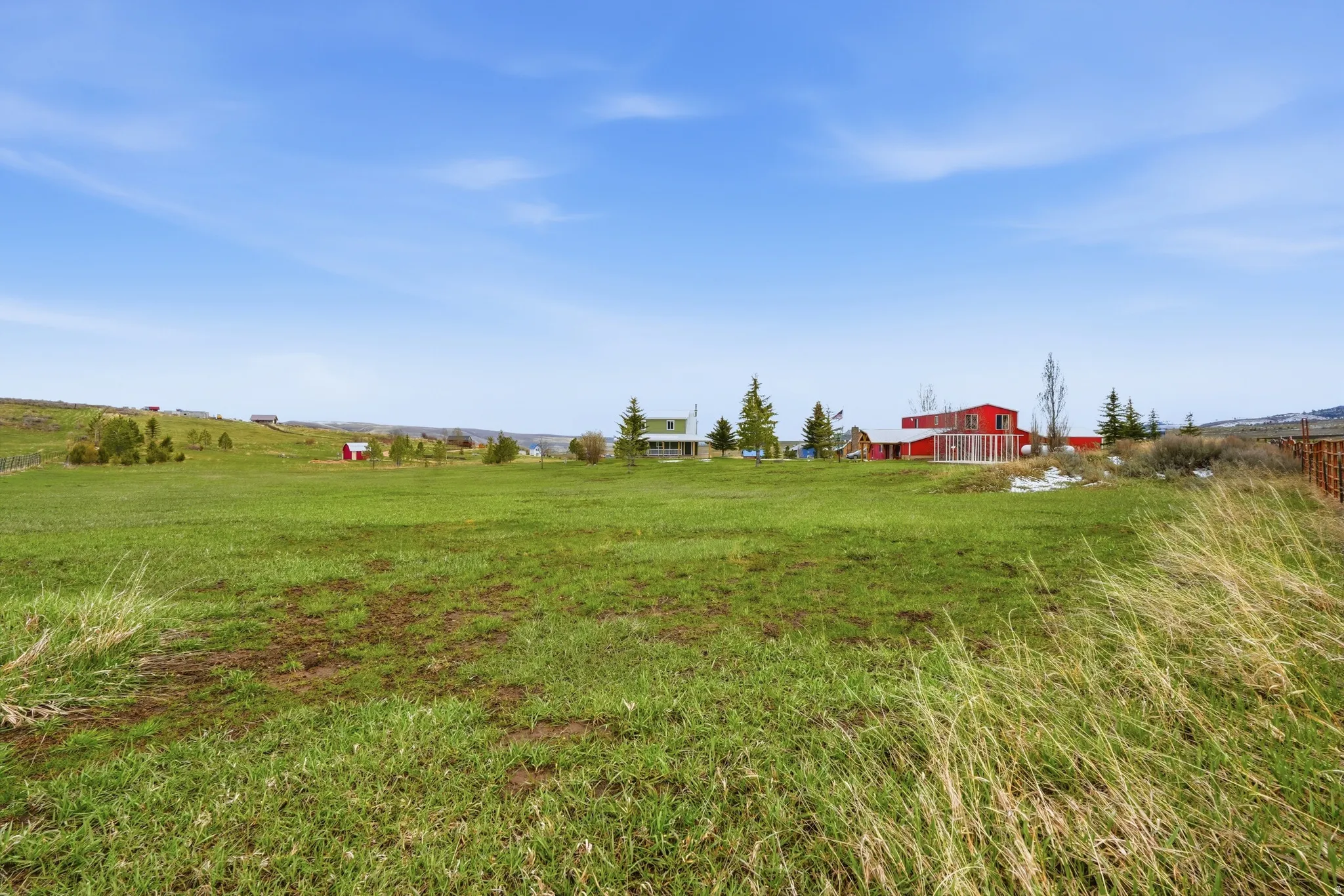 View of green lawn with a view of countryside