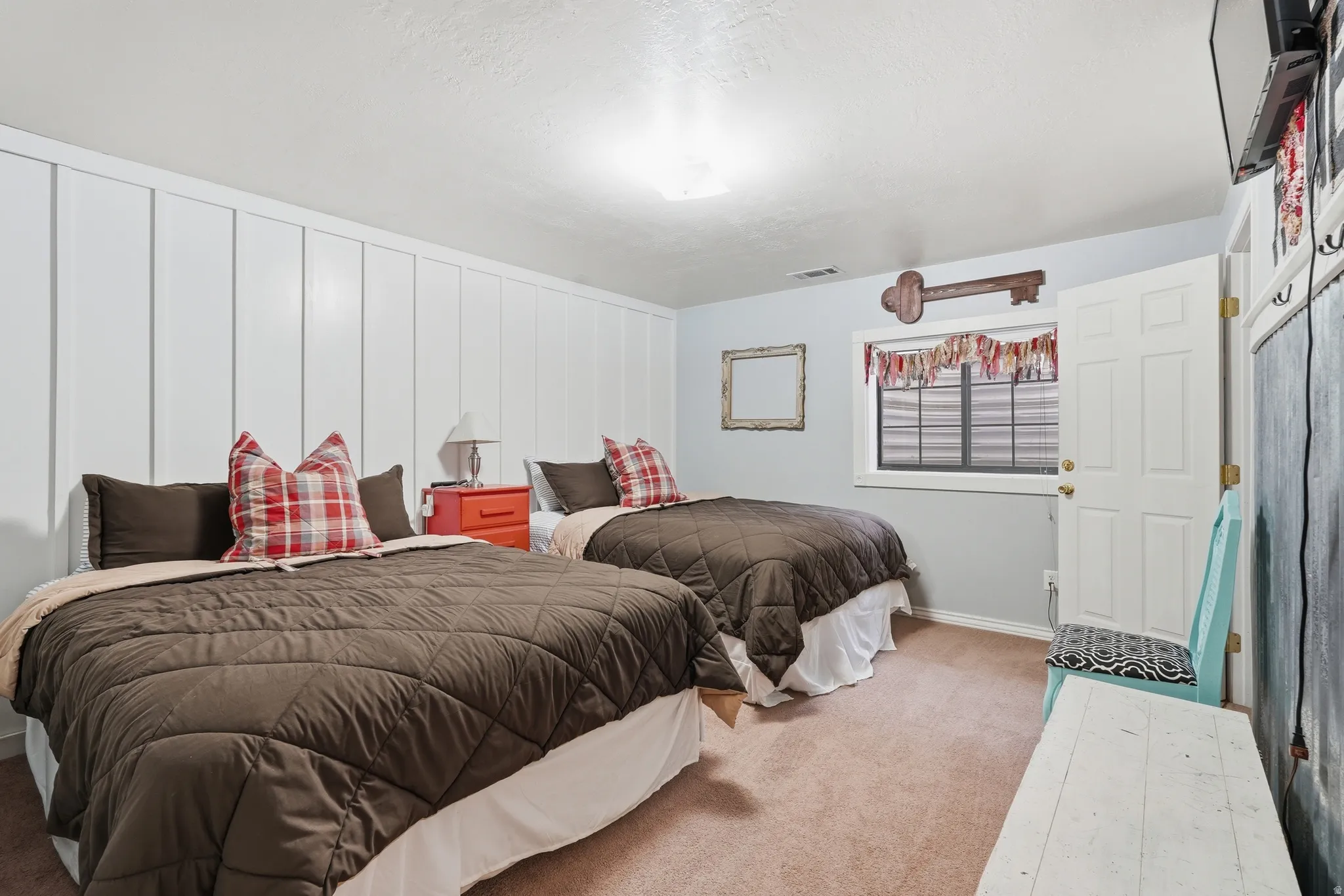 Carpeted bedroom featuring baseboards