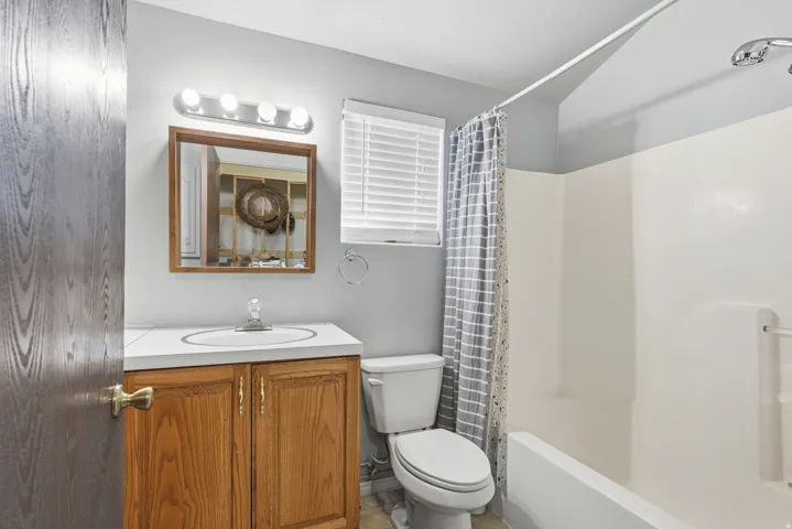 Full bathroom featuring vanity and shower / bath combo with shower curtain