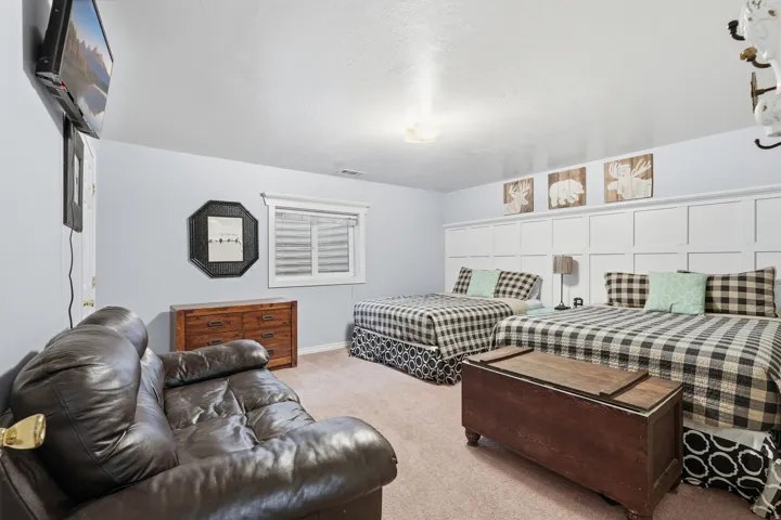 Bedroom with light colored carpet and baseboards
