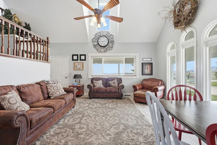 Living area featuring ceiling fan and lofted ceiling