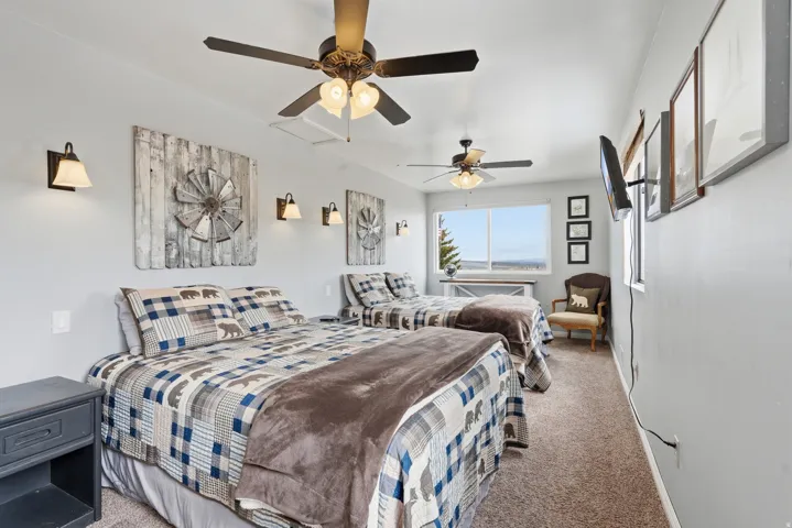 Bedroom featuring carpet and ceiling fan