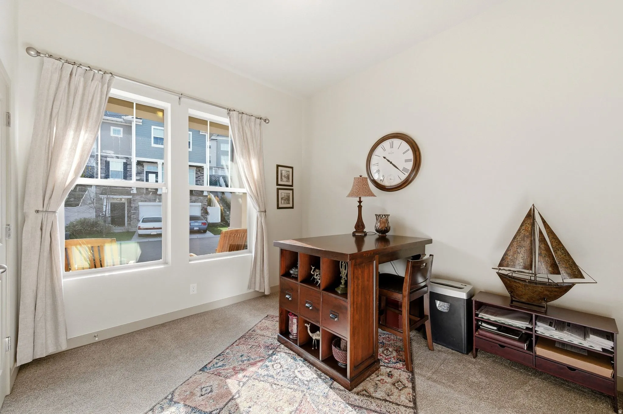 Bedroom #2 with large windows and light carpet