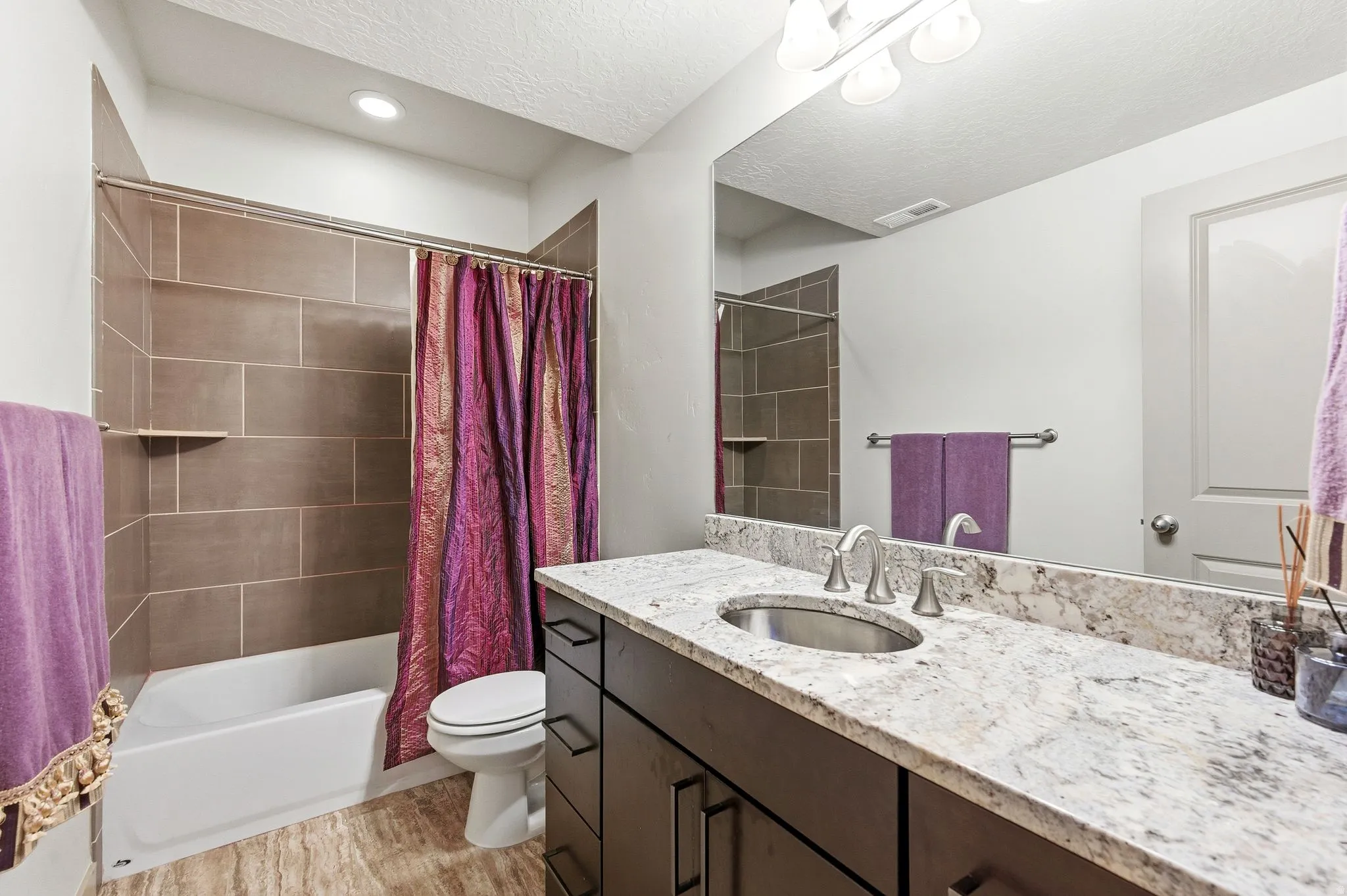 Downstairs hall bathroom, featuring combined tub and shower