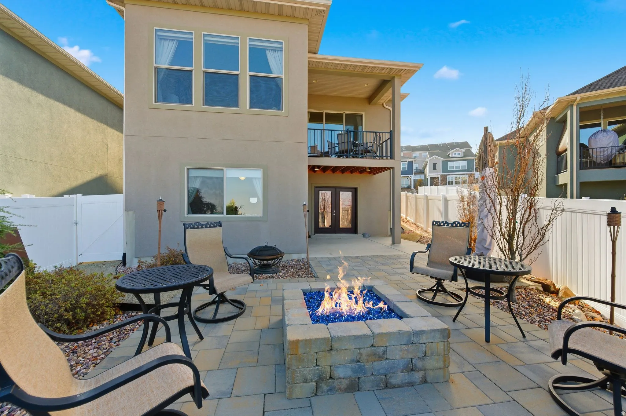 Back patio / terrace featuring french doors, a fenced backyard, and gas fire pit