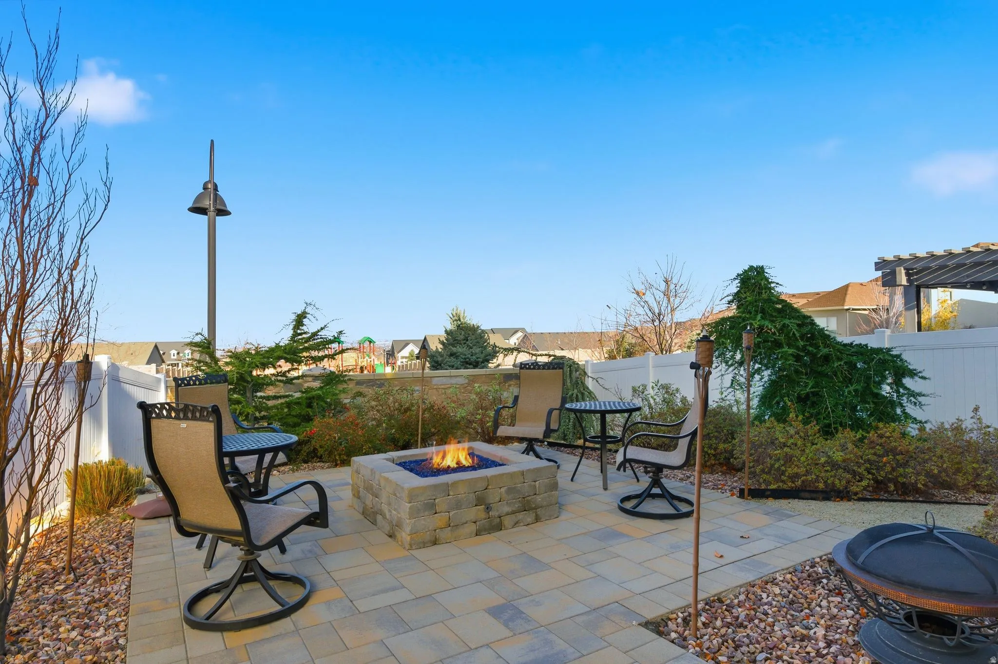 Back patio within a fenced backyard and gas fire pit