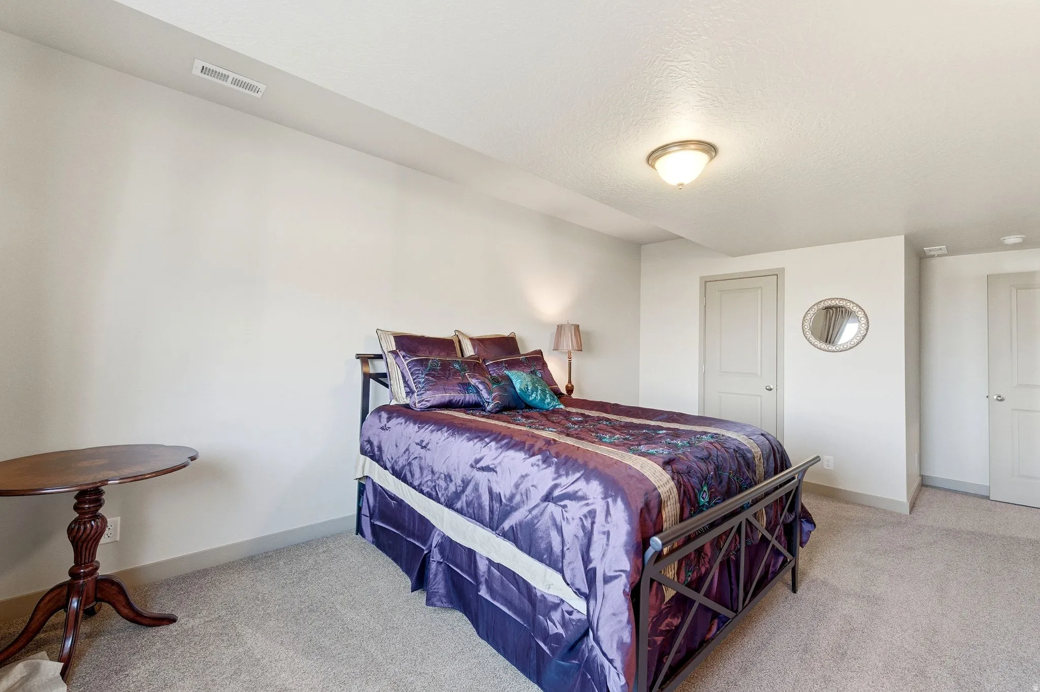 Bedroom #4 featuring light carpet and a textured ceiling