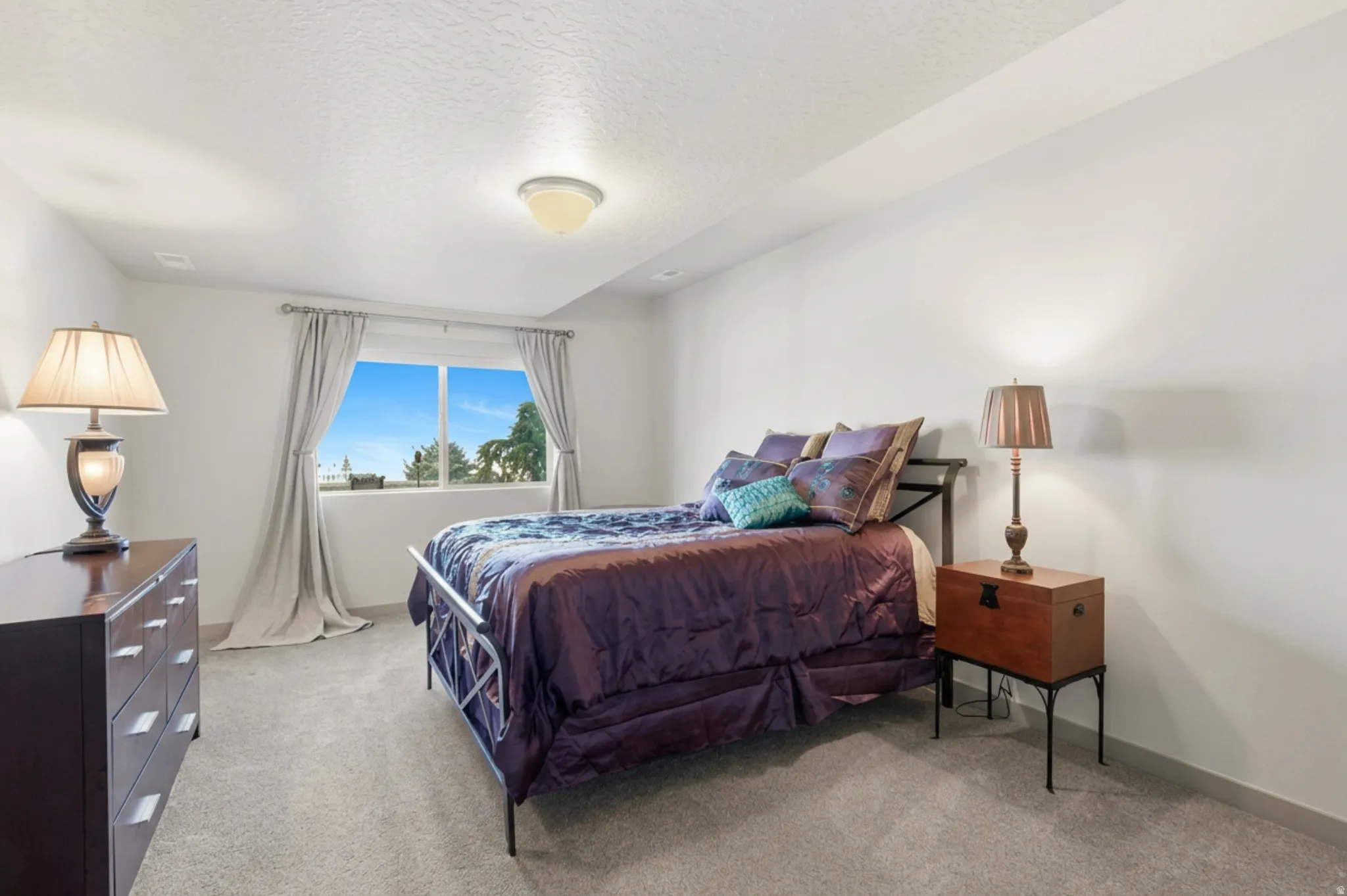 Bedroom #4 featuring light carpet and a textured ceiling