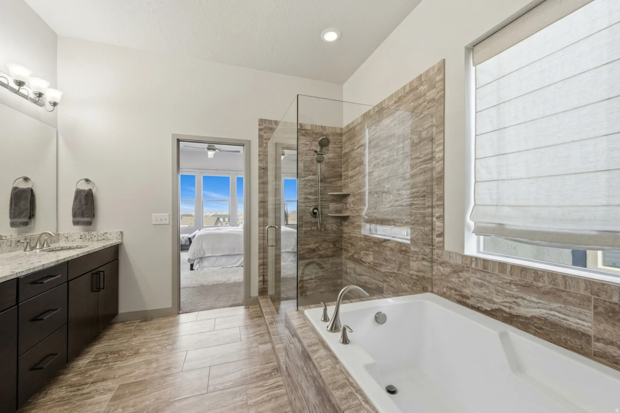 Primary ensuite bathroom featuring double vanity, and separate garden tub and shower