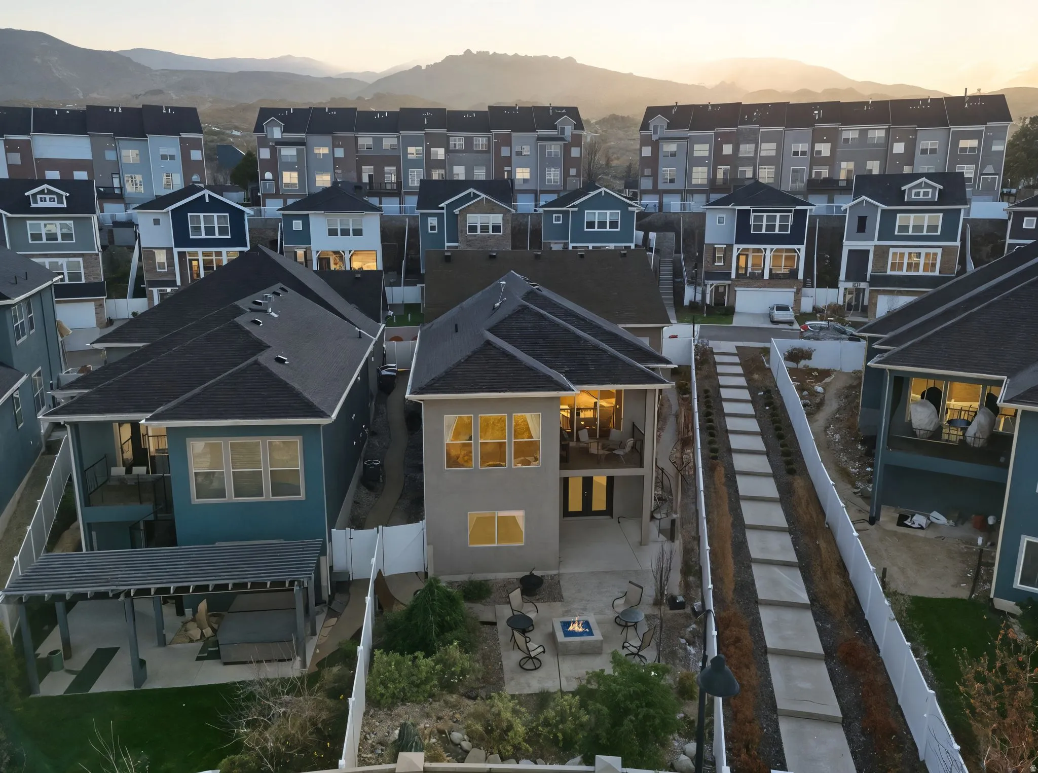 Aerial view of backside of house at dusk of a residential mountain view