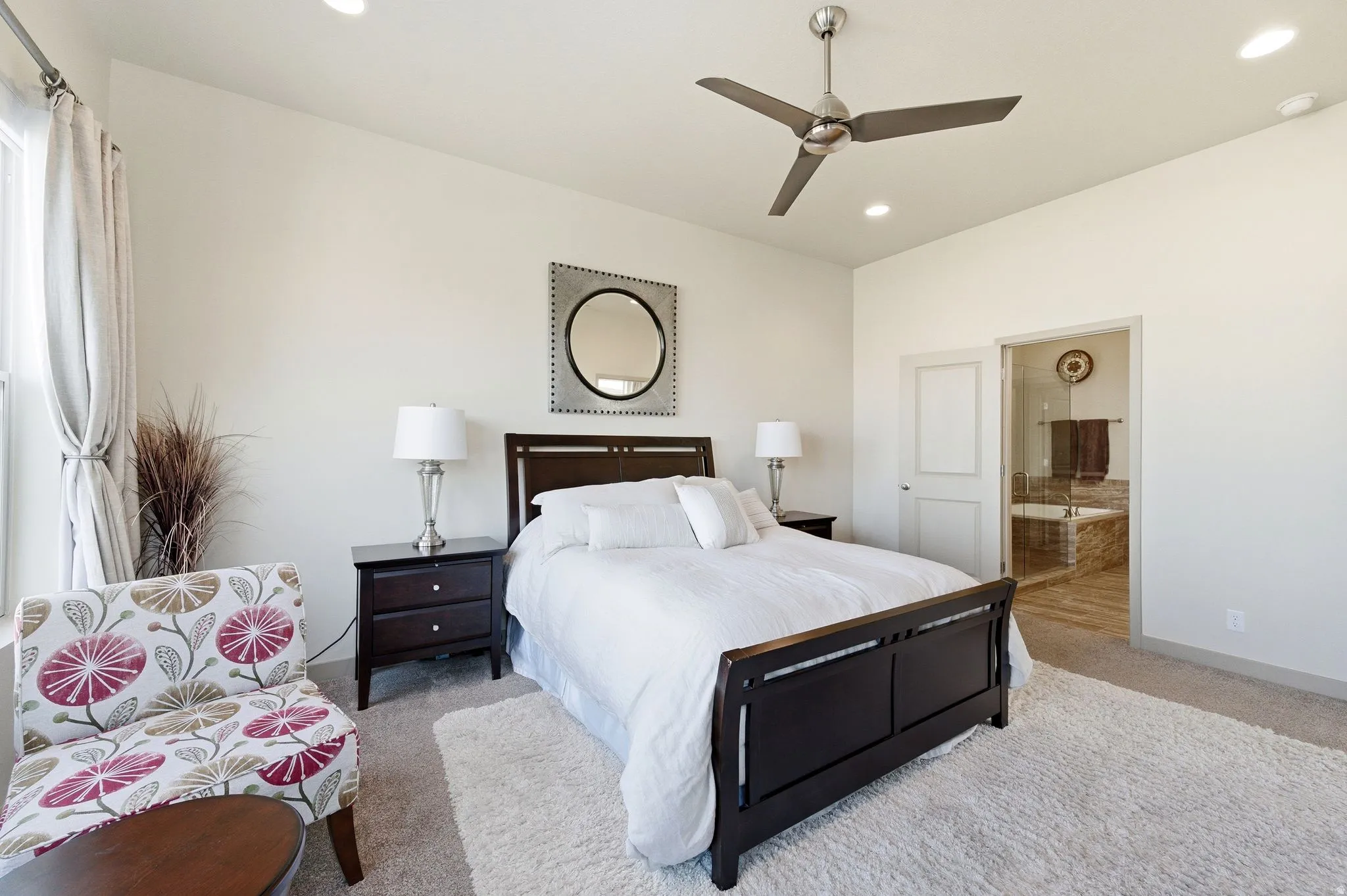 Primary bedroom with carpet floors, ceiling fan, ensuite bathroom, and recessed lighting
