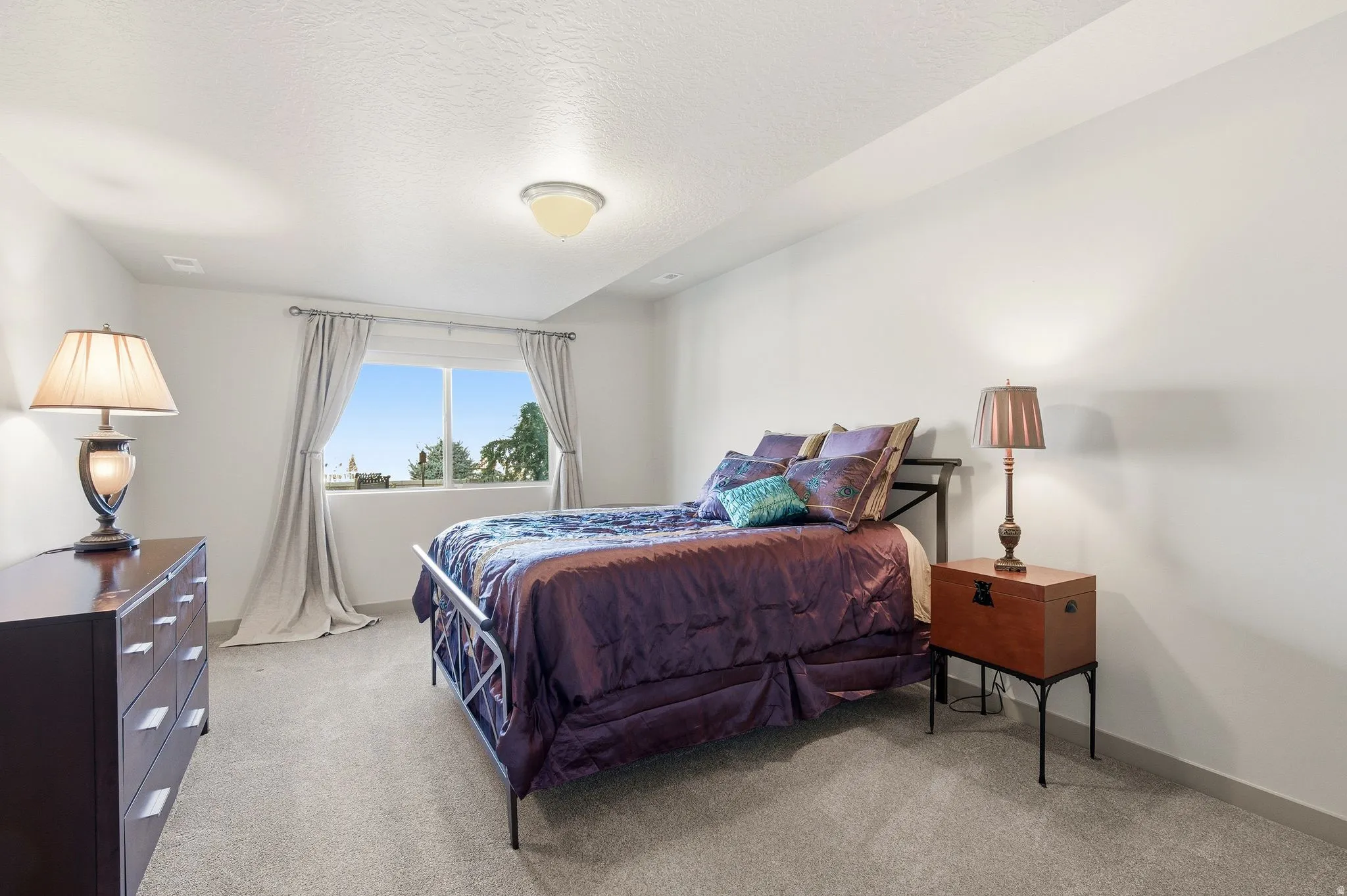 Bedroom #4 featuring light carpet and a textured ceiling