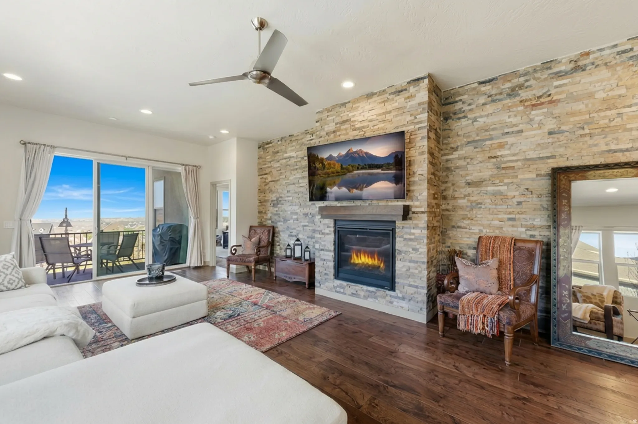Living room with hardwood flooring, a fireplace, and sliding doors to back deck.
