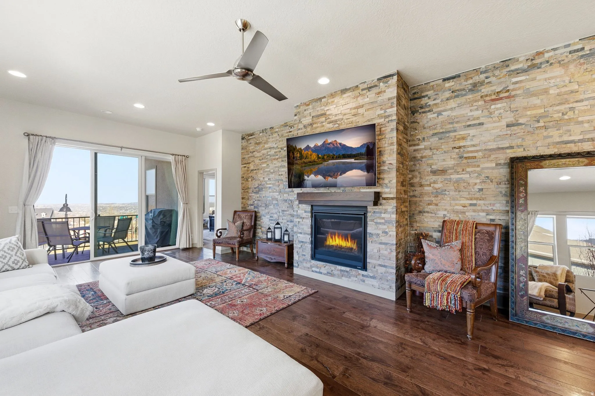 Living room with hardwood flooring, a fireplace, and sliding doors to back deck.