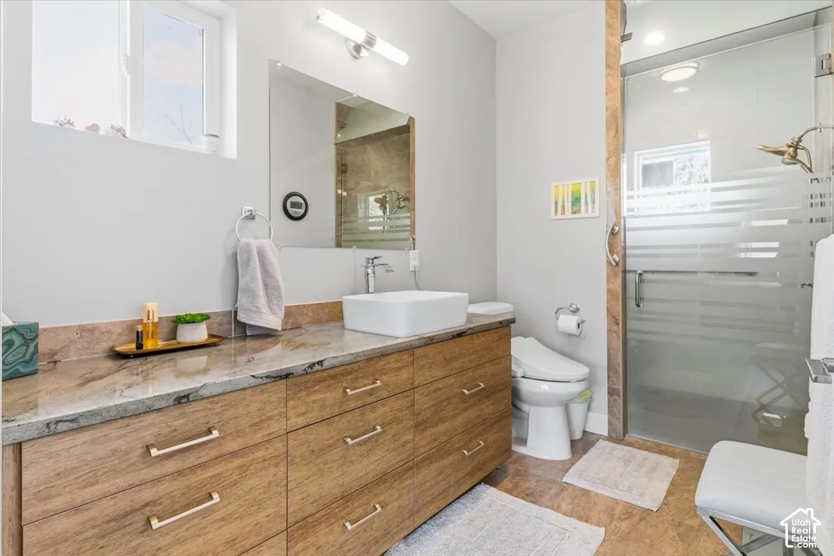 Full bathroom featuring vanity and a shower stall