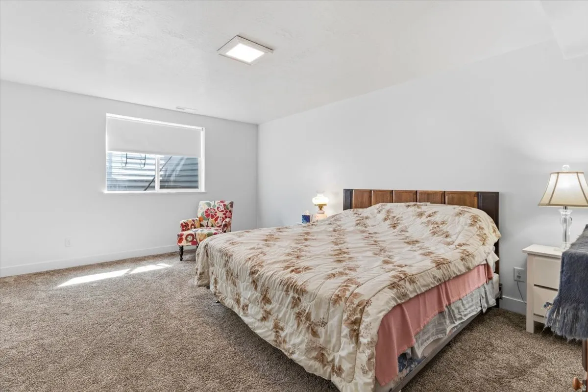 Bedroom featuring dark colored carpet