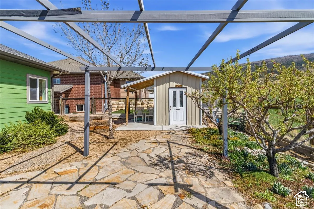 View of patio / terrace with an outbuilding and a lanai