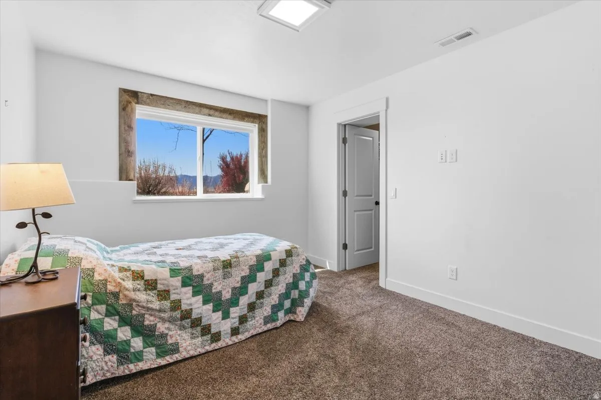 Bedroom with carpet flooring and baseboards
