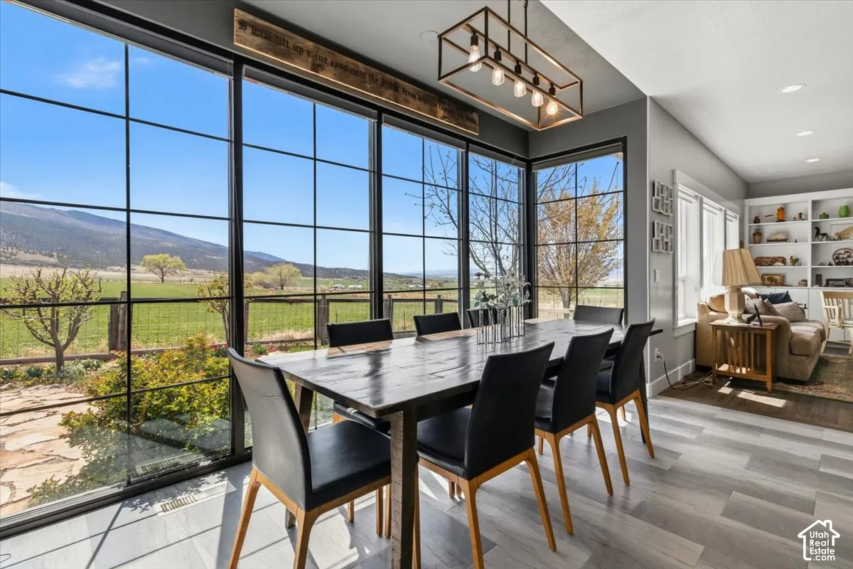Dining room with built in features, wood finished floors, recessed lighting, and a mountain view