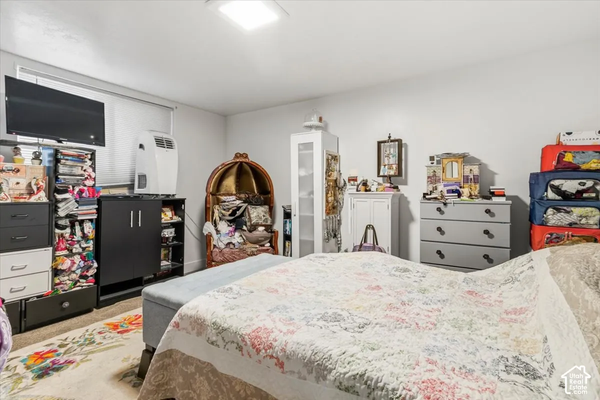 Bedroom featuring light colored carpet