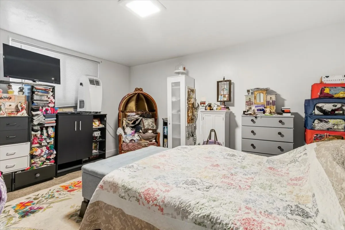 Bedroom featuring light colored carpet