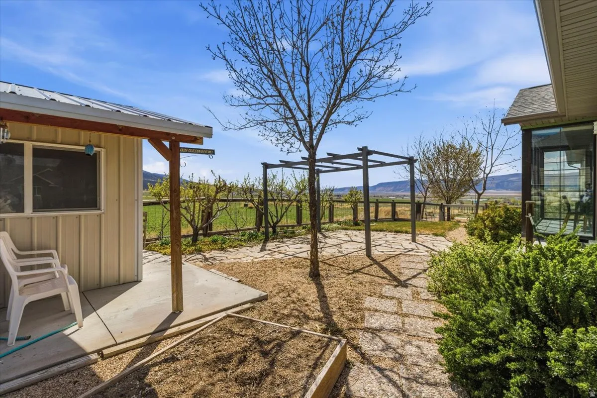 Fenced backyard featuring a patio area and a mountain view