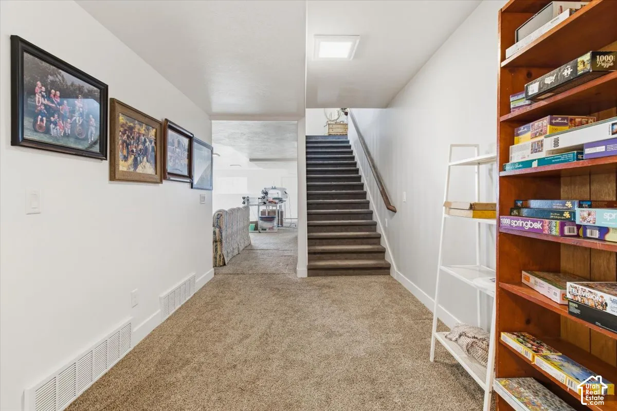 Stairway featuring carpet and baseboards
