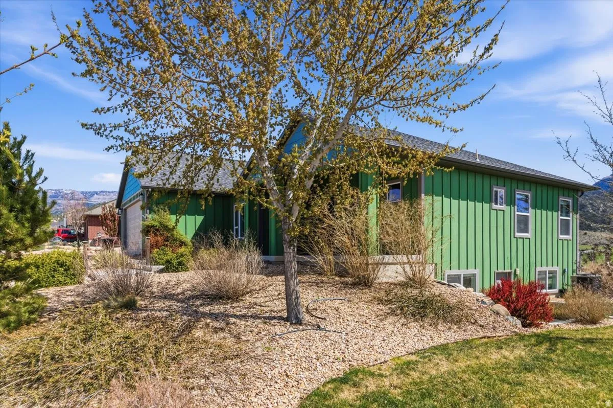View of front of house featuring board and batten siding and an attached garage