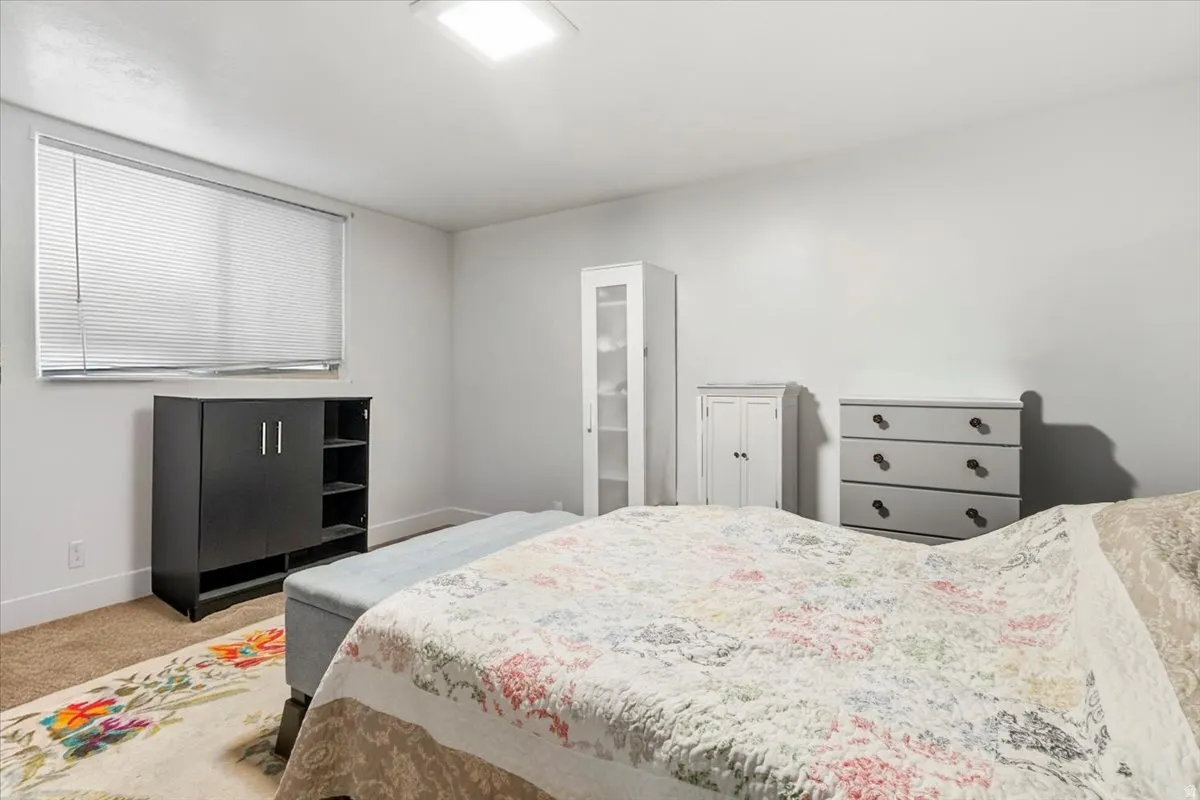 Bedroom featuring carpet flooring and baseboards